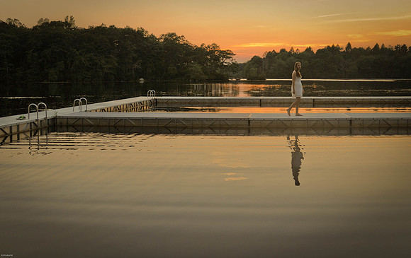 girl walking on floating dock on pond during sunset in Exeter ri