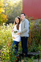 mom and dad holding ultrasound image of expectant baby