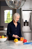 woman cutting vegetables on counter for webste use