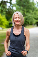 female nutrition coach jogging on Blackstone Boulevard path  in Providence