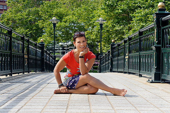 woman sitting on bridge posing