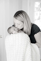 black and white image of  mom holding baby boy kissing him on cheek